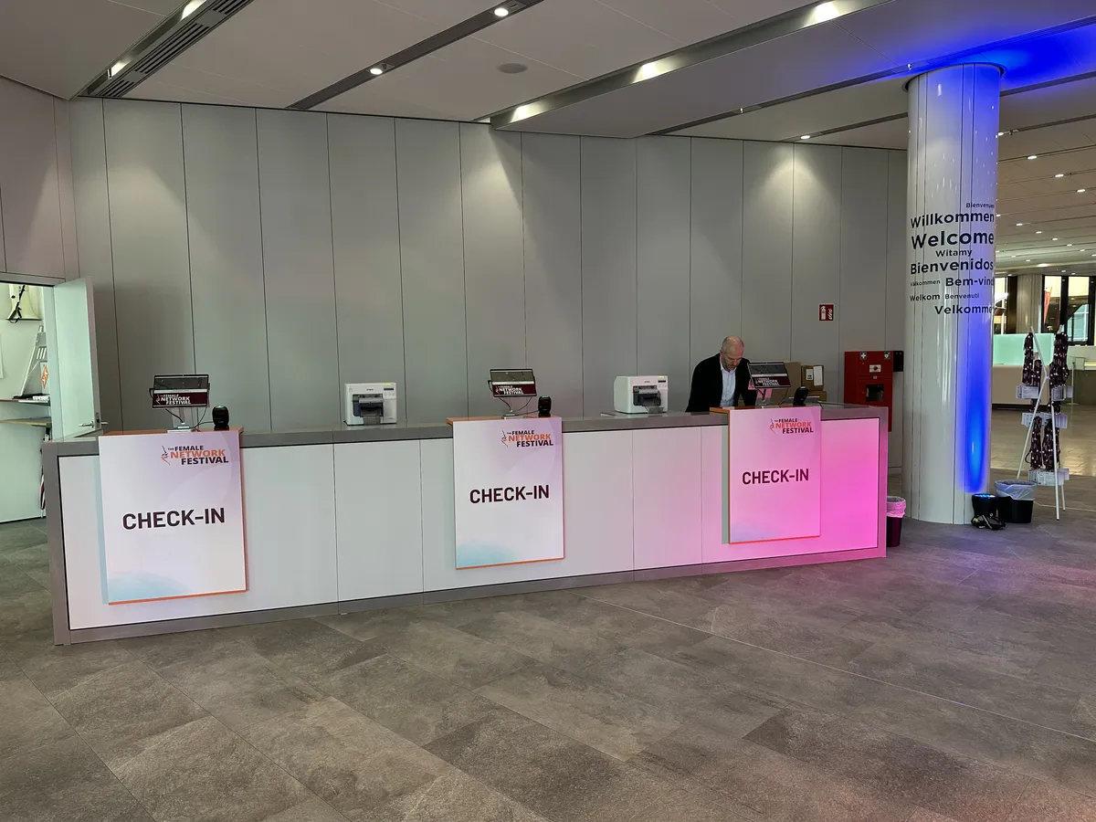 Check-in desks with tablets, scanners and badge printers at the Female Network Festival 2026
