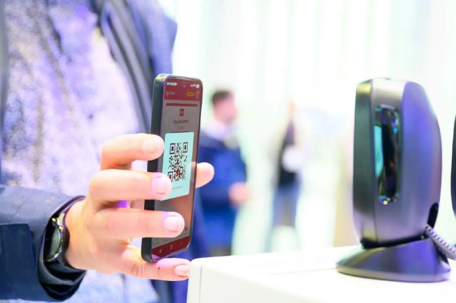 A ticket QR code on a phone is scanned at check-in at the European Collaboration Summit 2026